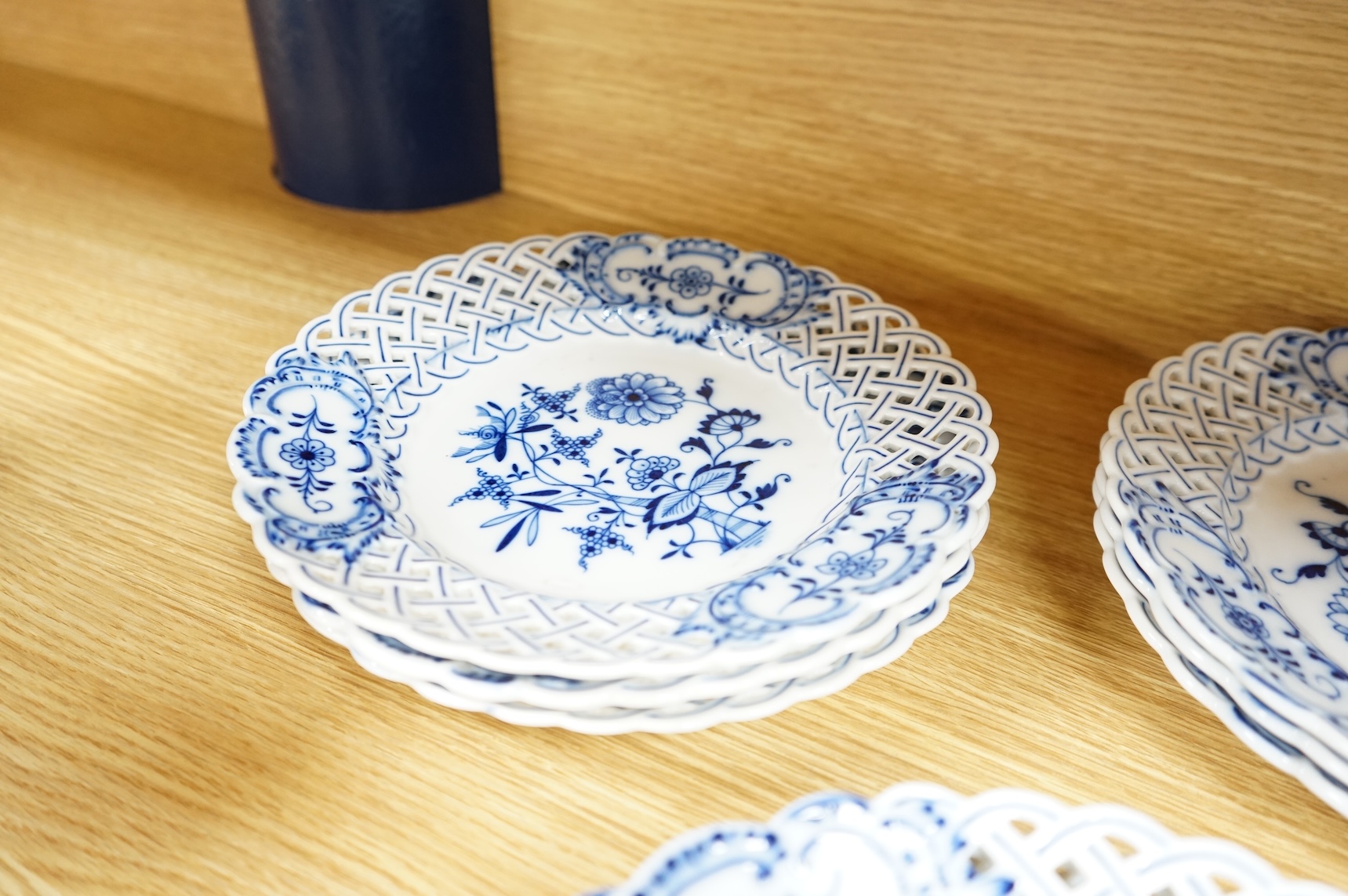 A ‘Meissen’ blue onion pattern dessert service comprising nine plates and two oval twin handled dishes, 24cm wide